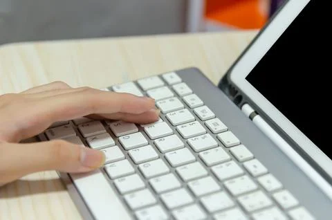 Girl using a computer keyboard. Studying online at home.Playing computer ga.. Stock Photos