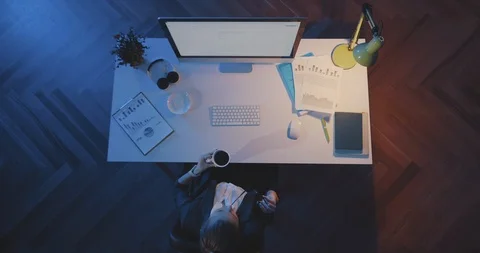 Girl using computer late at night in office 스톡 동영상 111564437