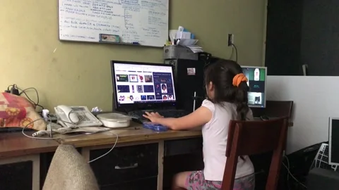 A girl using a computer sitting at the desk Stock Footage 146675412