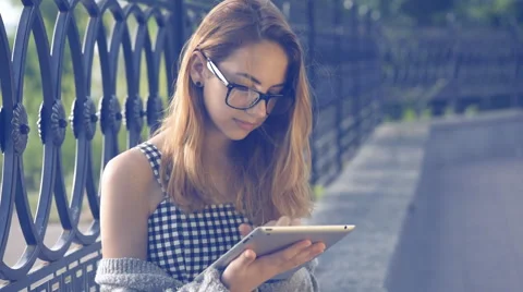 Girl using a digital tablet outdoors. Stock Footage 64380705