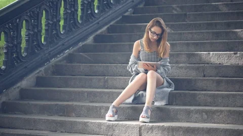 Girl using a digital tablet outdoors. Stock Footage 64383779