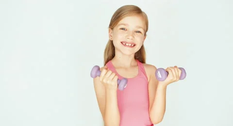Girl using dumbbell on a white background  with smile Video stock 53206535