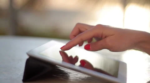 Girl using electronic tablet on the beach at sunrise Видео 49525604