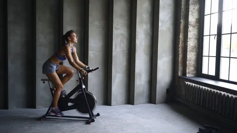 Girl using exercise equipment in modern gym 스톡 동영상 123073791