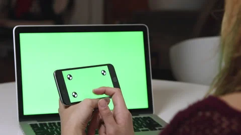 Girl Using a green screen iphone and macbook pro Stock Footage 59767724