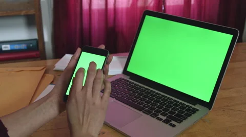 Girl Using a green screen iphone and macbook pro Stock Footage 59772778