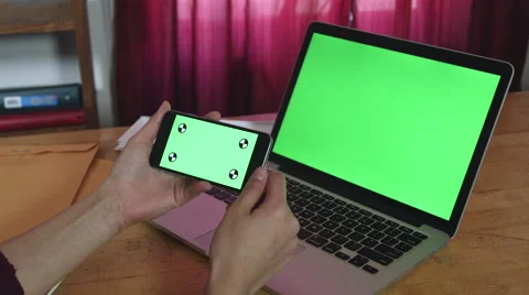 Girl Using a green screen iphone and macbook pro Stock Footage 59774240