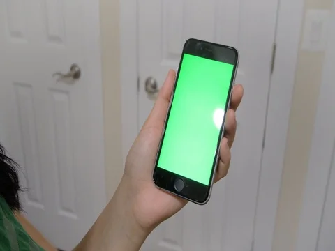 Girl using green screen iphone Stock Footage 80359757