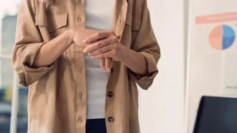 Girl Using Hand Antiseptic at Work. Woman Using Hand Sanitizer at Creative Stock Footage 217517563