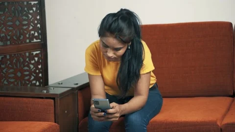 Girl using her phone, thinking and smiling Stock Footage 150198447