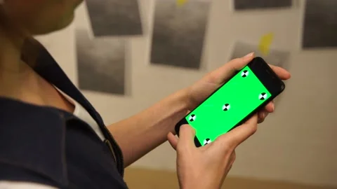 A girl using her smartphone. Trying to find a design solution. Stock Footage 144865942