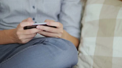 Girl using her smartphone while sitting down in bed Stock Footage 66469118