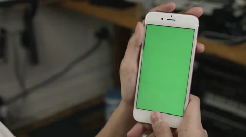 Girl using her white green screen smart phone in her office Free Stock Footage 62913559