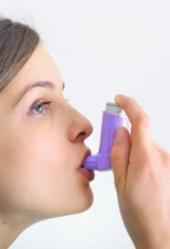 Girl using an inhaler for Asthma Stock Photos
