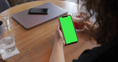 Girl Using iPhone 11 Pro Max with Green Screen chromakey. Stock Footage 135814839