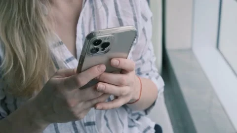 Girl using iPhone 12 smartphone pressing finger, reading social media internet 스톡 동영상 171136461