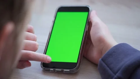 Girl using iPhone 13 Pro viewing green screen. 12.02.22 Minsk,  Belarus Stock Footage 170321809
