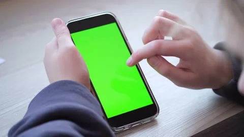 Girl using iPhone viewing green screen on phone 12.02.22 Minsk,  Belarus Stock Footage 170321808