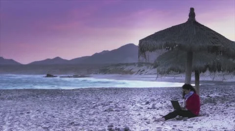 Girl using laptop on beach Stock Footage 10817792