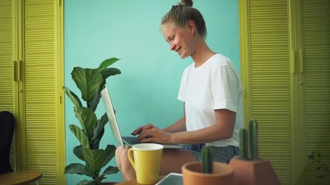 Girl using laptop computer in bright interior background rapid slow motion Video stock 87609998