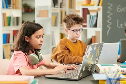 Girl using Laptop in Computer Class Stock Photos