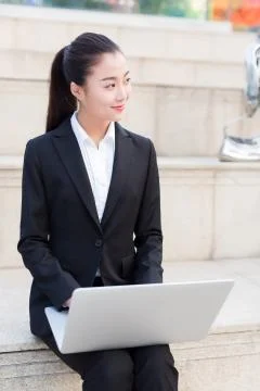Girl using a laptop computer Stock Photos