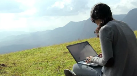 Girl using laptop in mountain Stock Footage 10685589