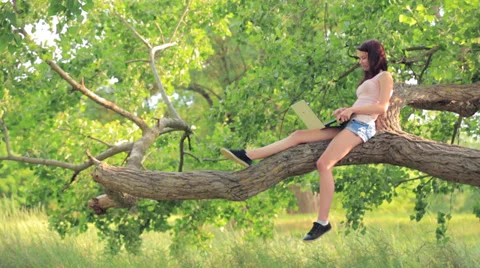 Girl Using Laptop Sitting On The Tree Stock-Footage 36572803