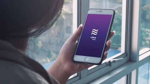 Girl using libra currency e-wallet application on smartphone Stock Footage 116915823