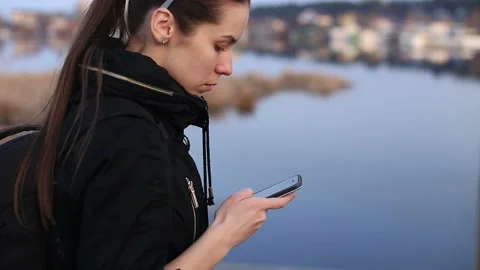 A girl is using a mobile phone Stock-Footage 87389463