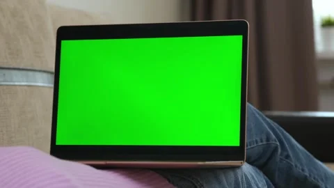 Girl using mobile phone with green screen while lying on sofa at home Stock-Footage 320776949