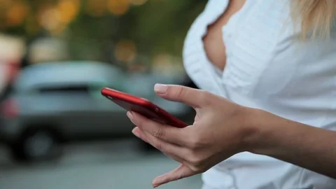 Girl using mobile phone - Smartphone in th city. Young beautiful blonde Stock Footage
