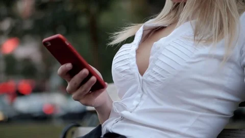 Girl using mobile phone - Smartphone in th city. Young beautiful blonde Stock Footage