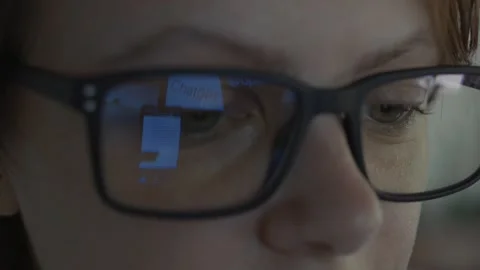 Girl using Open AI Chat GPT. Reflection in glasses. Close up. Stock Footage 241719976