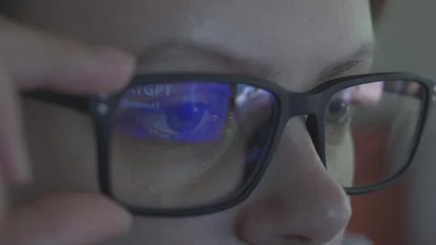 Girl using Open AI Chat GPT. Reflection in glasses. Close up. Stock Footage 241720037
