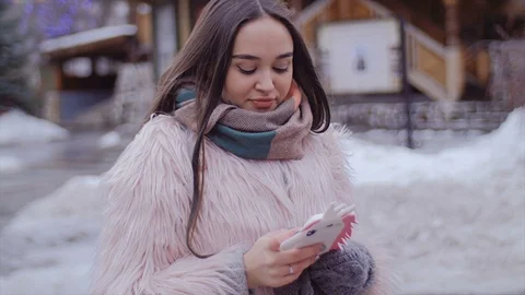 The girl is using the phone. Stock Footage 73911999