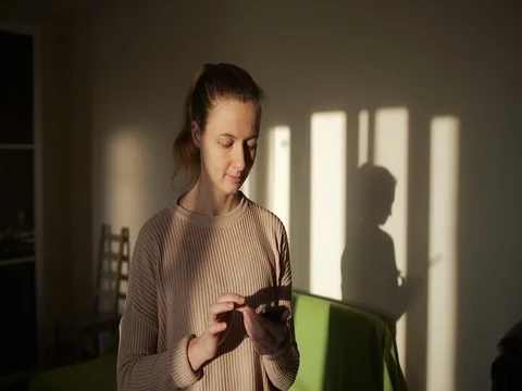 Girl using Phone Sitting at Home befor the Train and Searching new Exercises Stock Footage