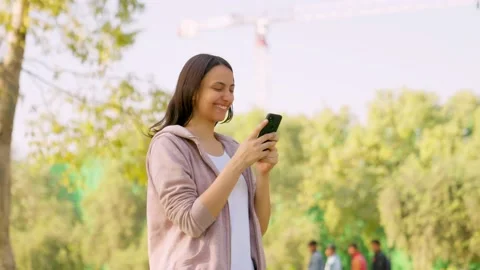Girl using phone while walking Stock Footage 230581949