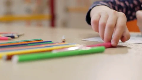 Girl using a pink felt-tip pen draws on paper Stock Footage 77056017