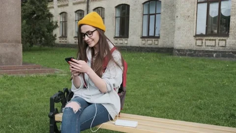 Girl using smart phone while charging on the power bank. Lifestyle with modern Stock Footage 197155085