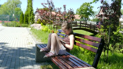 Girl Is Using Smartphone On A Bench In Park Stock Footage 86355745