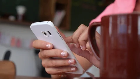Girl Using Smartphone in Cafe and Drinking Coffee Stock-Footage 74260616