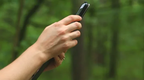 Girl using smartphone in forest, making photos. Full HD Stock Footage 58668545
