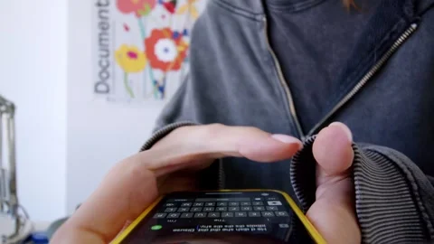 Girl using smartphone while doing homework. Young people and college education Stock Footage 254403720