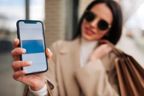 Girl using smartphone while making contactless payment . 스톡 사진