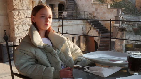 Girl using smartphone while sitting at table in cafe Video stock 162099337