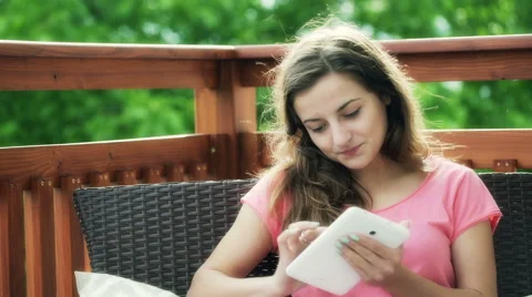 Girl using tablet and smiling to the camera on the terrace Video stock 54076704