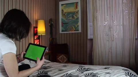 Girl using tablet on bed Видео 47983589