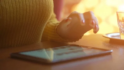 Girl using tablet in the cafe. Blurred background with lens flare effects Stock Footage 72308909