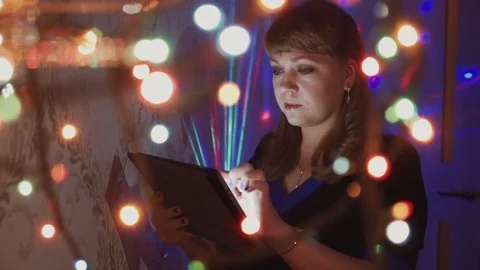 Girl using a tablet computer on Christmas eve close-up Stock Footage 81607990